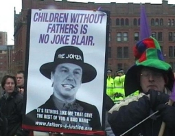 fathers 4 jusrice photo: person with banner 'children without fathers is no joke Blair' and bleow the picture of Tony Blair 'it's father like me that give the rest of you a bad name'